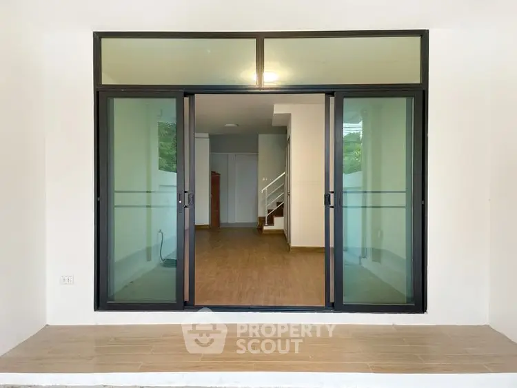 Modern interior with sliding glass doors and wooden flooring