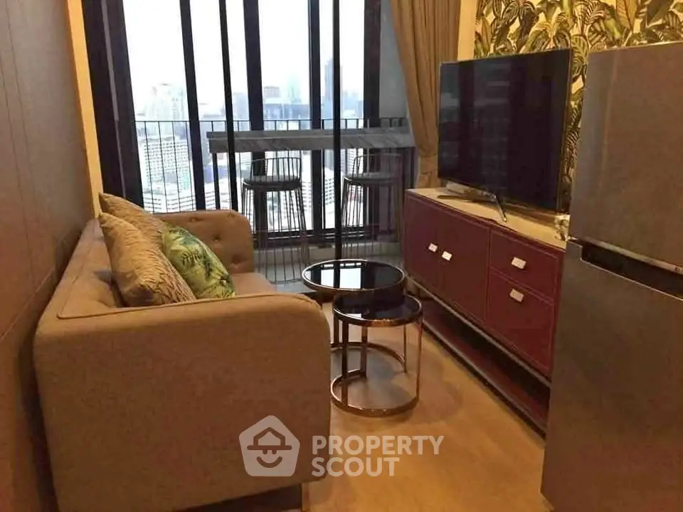 Stylish living room with city view, modern sofa, and sleek TV setup in urban apartment.