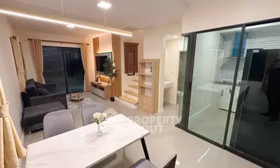 Modern open-plan living room with dining area and stylish kitchen