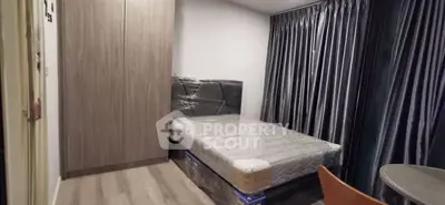 Modern bedroom with sleek wardrobe and cozy bed, perfect for urban living.