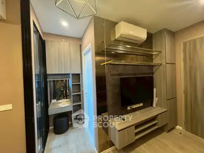Modern living room with sleek design, featuring built-in shelves, air conditioning, and stylish lighting.