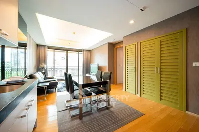 Modern living room with stylish furniture and large windows offering city views