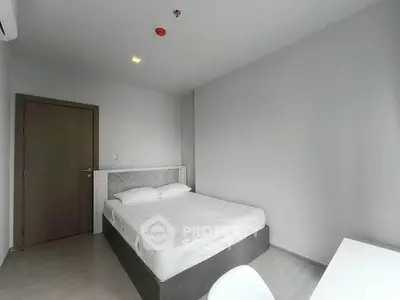 Modern minimalist bedroom with sleek design and neutral tones, perfect for a cozy retreat.