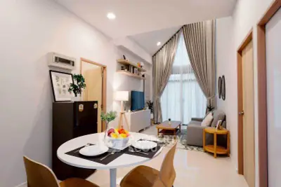 Modern living room with high ceilings and elegant decor in a stylish apartment.