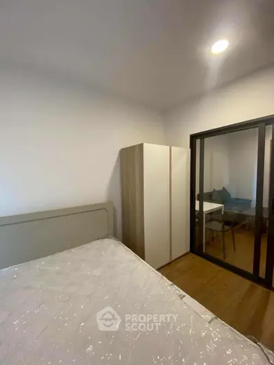 Modern bedroom with sliding glass door and cozy interior design