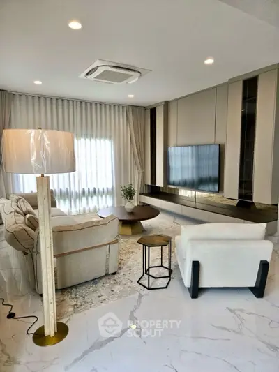Luxurious modern living room with elegant decor and large TV