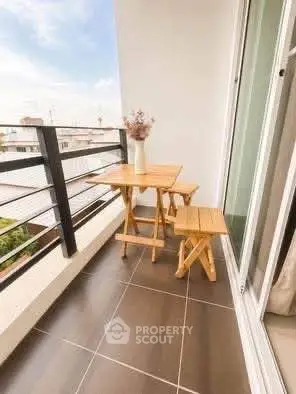 Charming balcony with cozy wooden furniture and scenic view, perfect for relaxation.