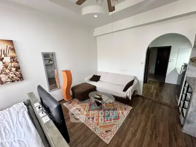 Charming living room with cozy decor and modern furnishings in a stylish apartment.