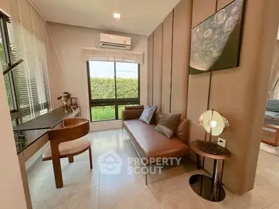 Stylish modern living room with leather sofa and garden view