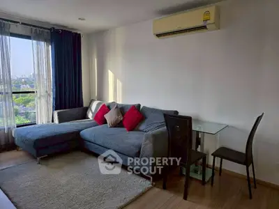 Modern living room with large sofa and city view window