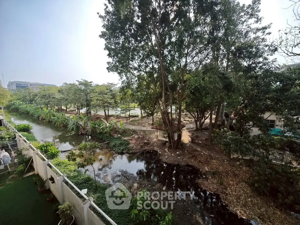 Scenic garden view with lush trees and serene water feature