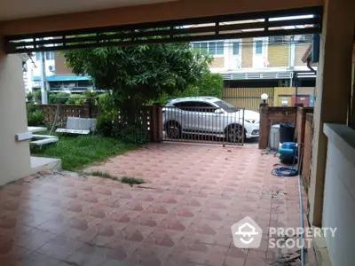 Spacious tiled patio with garden view and car parking area