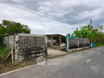 Explore this rustic property with potential for development, featuring a spacious open area and sturdy fencing.