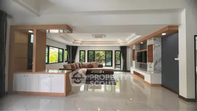 Spacious modern living room with elegant decor and large windows for natural light.