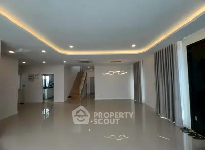 Spacious modern living room with elegant lighting and glossy flooring