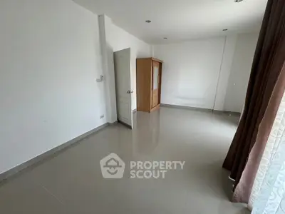 Spacious unfurnished room with large window and wardrobe, perfect for customization.