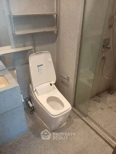 Modern bathroom with sleek toilet and glass shower enclosure