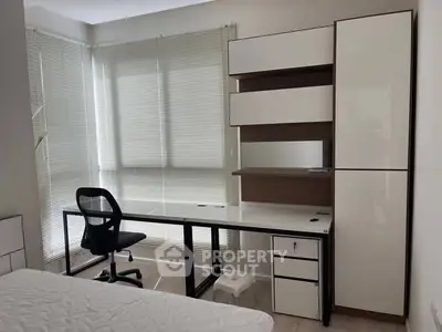 Modern study room with sleek desk and chair, perfect for productivity.