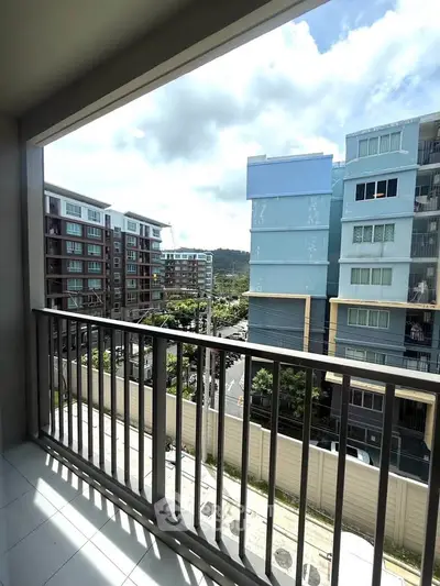 Spacious balcony with scenic urban view in modern apartment complex