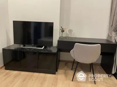 Modern study area with sleek desk and TV stand in stylish apartment