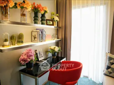 Stylish living room with modern decor and vibrant red chair