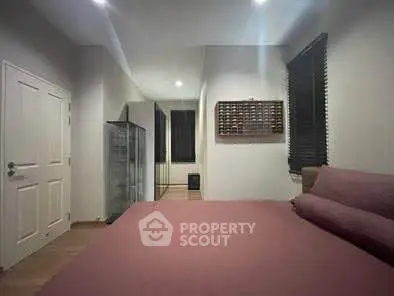 Spacious bedroom with modern decor and ample natural light