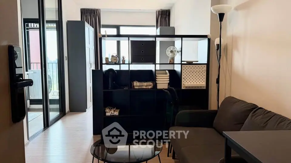 Modern living room with stylish furniture and balcony access