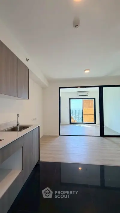 Modern open-plan kitchen and living area with sleek finishes and ample natural light.