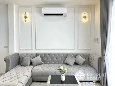 Elegant living room with plush gray sofa and modern wall sconces