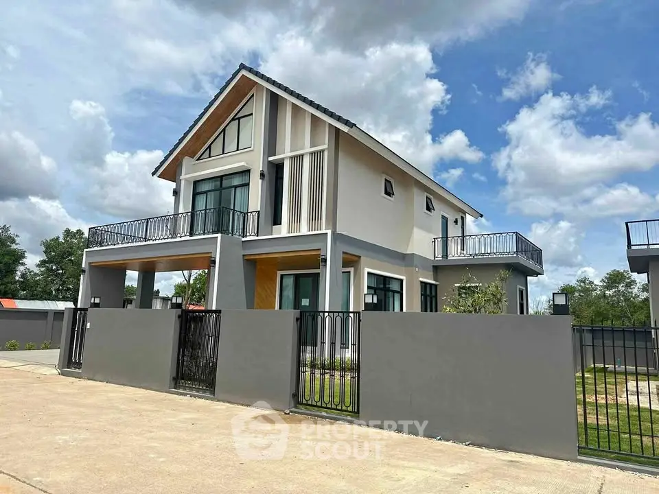 Modern two-story house with large windows and spacious balconies in a serene neighborhood.