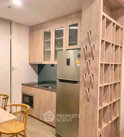 Modern kitchen with sleek wooden cabinetry and stainless steel appliances