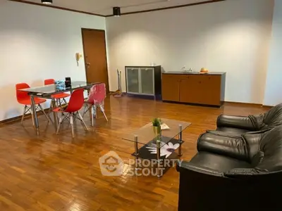 Spacious living room with wooden flooring, modern furniture, and stylish decor