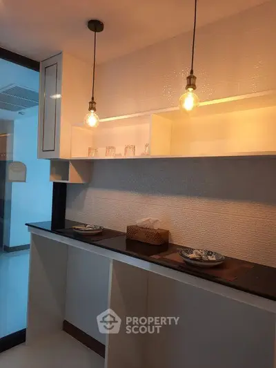 Modern kitchen with open shelving and stylish pendant lighting