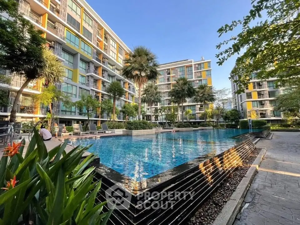 Luxurious apartment complex with stunning pool and lush greenery