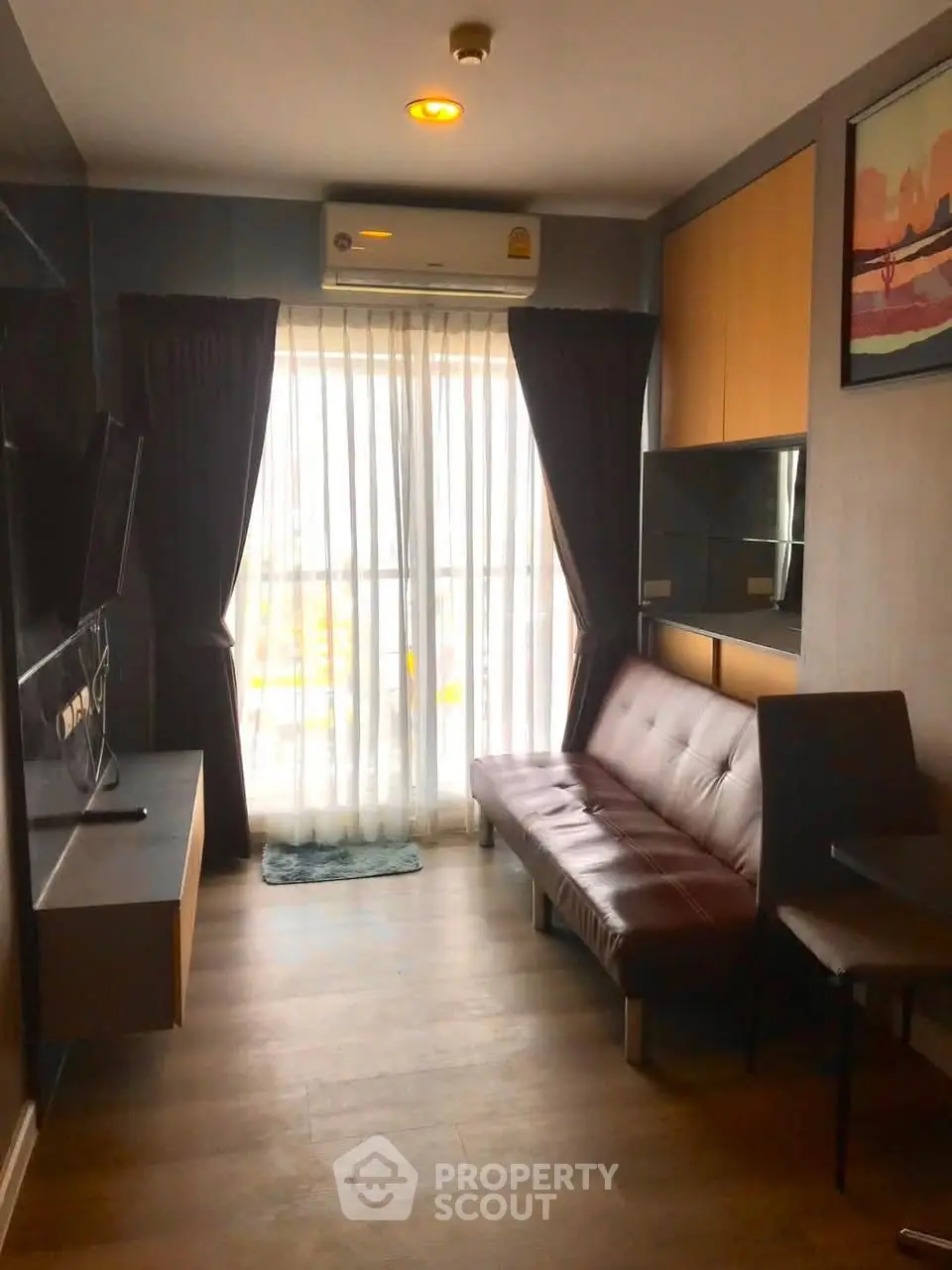 Cozy living room with modern decor and natural light from large window