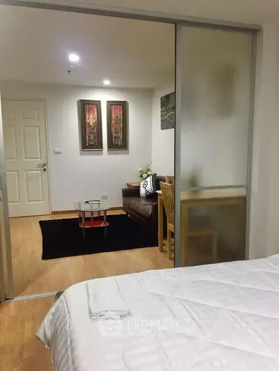 Cozy living room with sliding glass doors and modern decor in a stylish apartment.