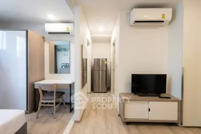 Modern apartment interior with sleek furniture and efficient layout, featuring air conditioning and stylish decor.