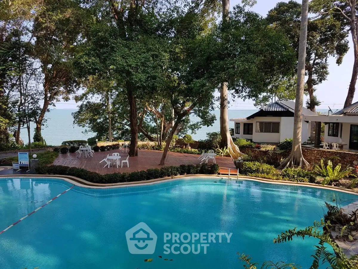 Stunning beachfront property with pool and lush greenery, perfect for relaxation and luxury living.