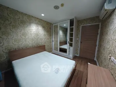 Modern bedroom with stylish wallpaper and mirrored wardrobe in cozy apartment