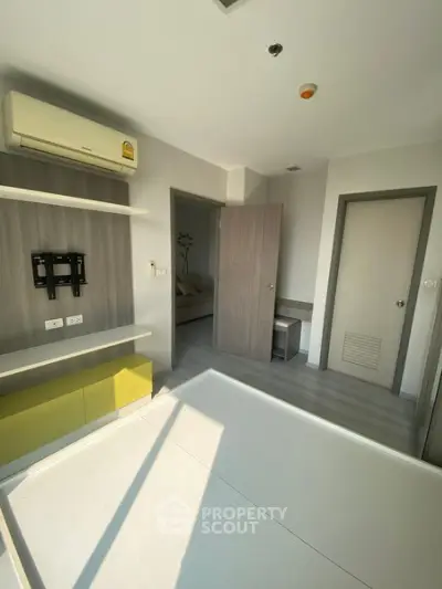 Modern bedroom with air conditioning and built-in storage in a stylish apartment.