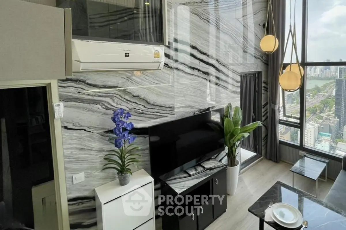 Luxurious modern living room with stunning city view and elegant marble wall design.