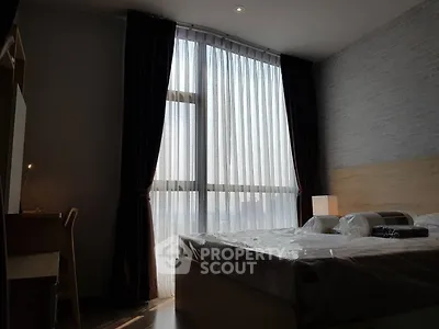 Cozy bedroom with large window and modern furnishings