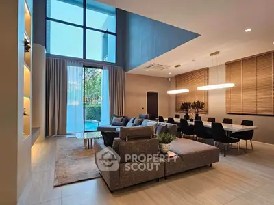 Luxurious modern living room with high ceilings and elegant dining area