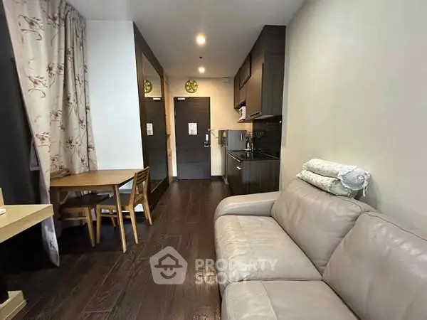 Modern living room with cozy sofa and dining area in open layout apartment.