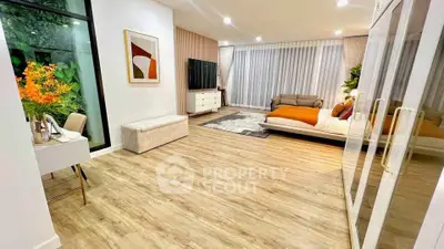 Spacious modern living room with stylish decor and large windows