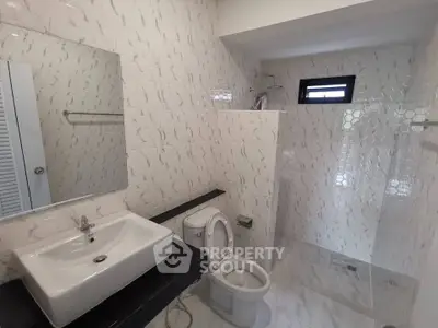 Modern bathroom with sleek white tiles and contemporary fixtures
