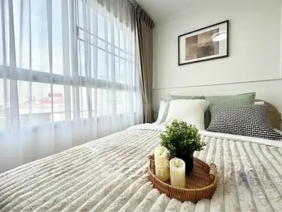 Bright and cozy bedroom with large window and stylish decor