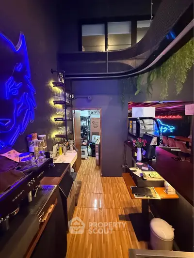 Stylish modern kitchen with neon lighting and open layout