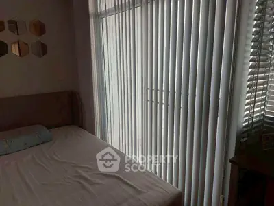 Cozy bedroom with vertical blinds and modern decor