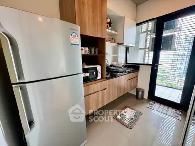 Modern kitchen with sleek appliances and balcony view
